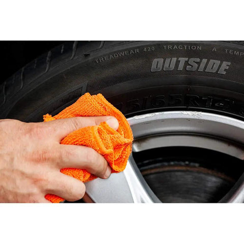 Applying Solid Alloy Wheel Repair Kit For Black Rims Smooths Out Curb Rash And Road Scuffs DIY on a silver alloy wheel.