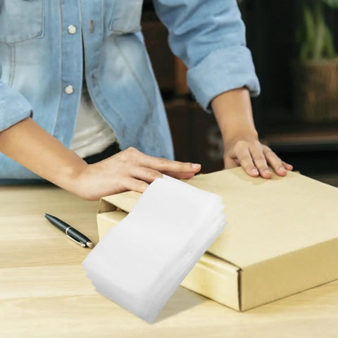 Stack of EPE Foam Pouches for Packing Dishes and Protecting Electronics shown next to a person packing a box