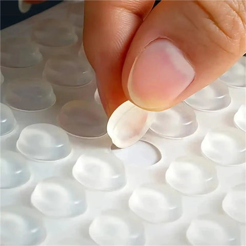 Close-up of a hand peeling a silicone pad from a sheet, part of Bulk 1000 Pack Silicone No Slip Pads For Drawers And Cabinets.