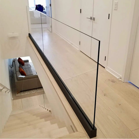 Heavy Duty Glass Railing System For Deck And Balcony Featuring Rock Solid Spigot Clamps With Flexible Floor Or Side Mount Hardware And Premium Aluminum Posts In Matte Black Covers for indoor staircase.