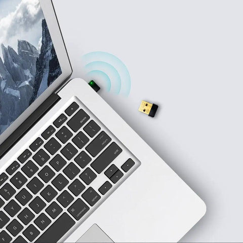 USB WiFi Adapter for PC N150 Nano Size Dongle plugged into laptop, emitting wireless signal, ideal for Windows Mac Linux use.