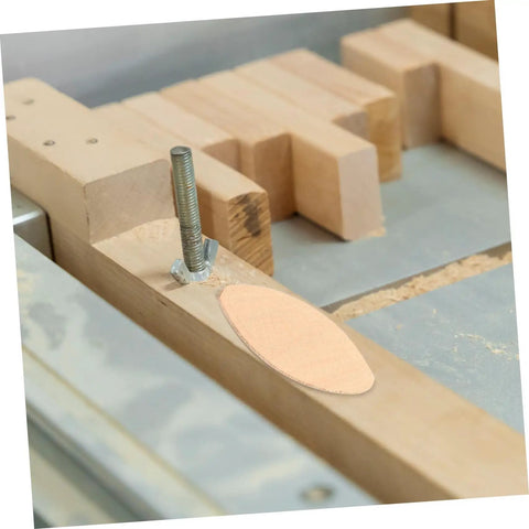 Top Shelf Wood Joining Biscuits And Joint Plates For Zero Hassle Furniture Assembly showing a wood biscuit aligned in a router slot.