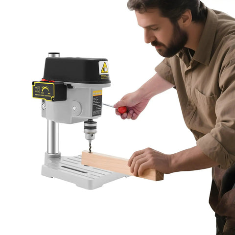 Man using compact benchtop drill press for precision metal and woodworking portable electric table drill with adjustable speeds.