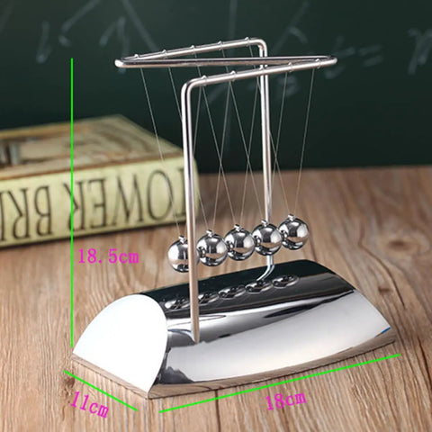 Z Shape Newton's Cradle Pendulum Balls on a wooden desk, showcasing five silver balls for energy transfer learning and decoration