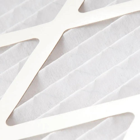 Close-up of pleated MERV 12 air filter for home HVAC systems showing filter material and design.