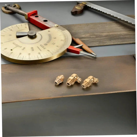 9 Piece Grease Fitting Assortment Kit With Copper Nipples For Cars And Trailers arranged on a workbench with tools