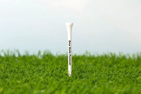 Funny Golf Tees 30 Pack Natural Wood Novelty Tees For Bachelor Parties And Groom Gifts, standing on grass