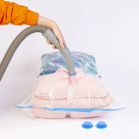 Ultimate Vacuum Seal Kit For Compression Bags being used to seal pink blanket with valve plugs and airtight caps visible