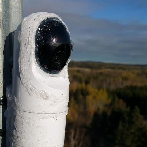 G3 Flex 1080p Indoor Outdoor Security Cam With Night Vision And HDR mounted on pole with scenic landscape in background