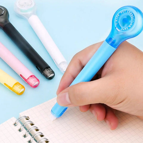 Smooth As Butter Pen Style Correction Tape Rollers With Zero Stink And Zero Drama Glide in blue color, held while correcting notes.