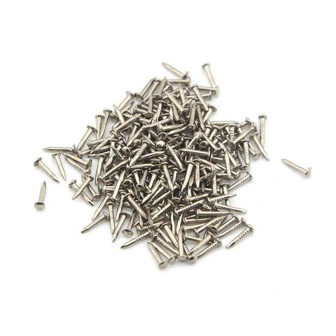 Badass Tiny Decorative Mini Nails For Sweet DIY Upgrades And Vintage Drawer Fixes Two Hundred Pack Flat Head Tin Tacks scattered on white background.
