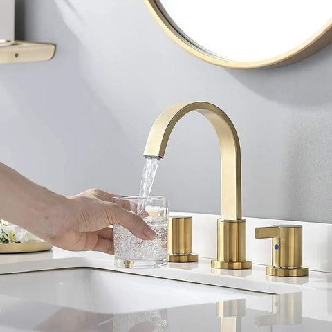 Two Handles 8 Inch Widespread Bathroom Faucet In Brushed Gold Finish With Valve And Metal Pop Up Drain Three Hole Mount Eight Inch Center Spread Sleek Modern Diy Bathroom Upgrade displayed with flowing water