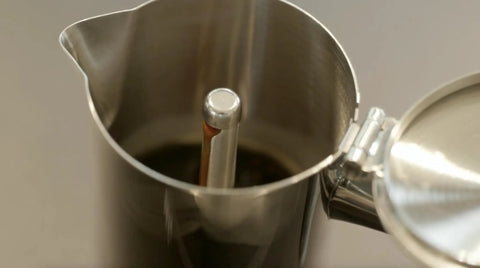 Close-up of Hella Durable Stainless Steel Stovetop Espresso Maker for rich coffee brews, revealing interior design and filter.