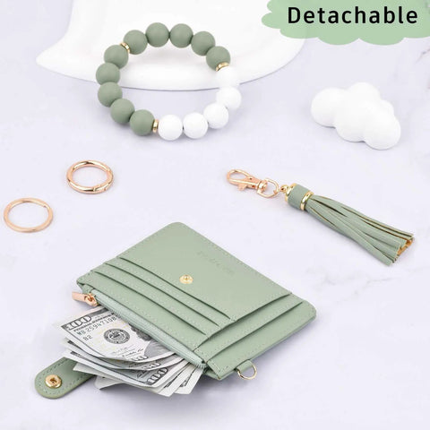 Green Wristlet Wallet For Women With RFID Blocking Card Holder Zipper Coin Pocket ID Window Detachable Slim Card Case on display with beaded bracelet, tassel, and cash