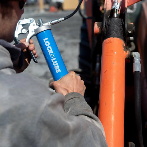 LockNLube heavy-duty pistol grip grease gun with blue body and attached hose, side view