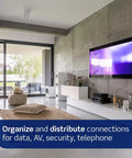 Modern living room showcasing media setup with a 28-Inch Wireless Structured Media Center With Vented Hinged Door White Finish.