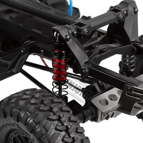 Close-up of RC Shock Absorber Set 4pcs Dampers on 1/10 RC Crawler Axial SCX10 frame, showing heavy duty metal build.