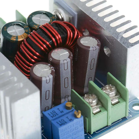 Close-up of a Beast Buck Converter Module 6-40V To 1.2-36V, 20A 300W Adjustable Step Down Regulator with heatsink and capacitors.