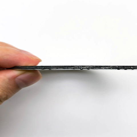 Side view of a black graphite exhaust gasket with fire ring for 3-inch muffler flange, 77mm ID