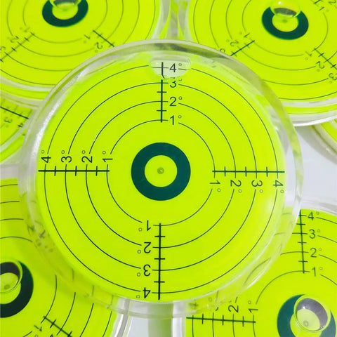 Rock Solid 80mm Round Spirit Level Featuring Degree Marked Surface And Oversized Bubble For Bang On Readings Heavy Duty Circular Measuring Device viewed from above with bright yellow surface.