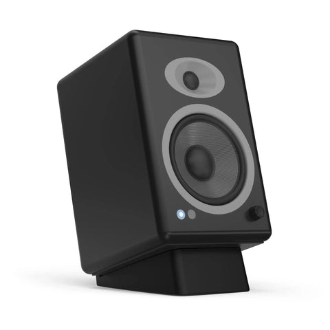 Angled Desktop Speaker Stands With Anti Slip Silicone Wedges For Medium Speakers, Vibration Resistant Riser in use with speaker.