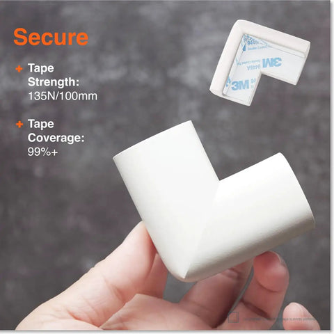 Heavy Duty Baby Proof Corner Protectors With No Fuss Pre Tape, Premium Thick Rubber Foam Edge Guards, Tough Non Toxic Impact Shields For Sharp Desks Tables And Fireplaces, Super Secure Hold 16 Pack in white being held.