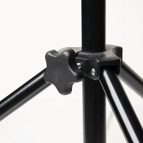 Close-up of a black star knob attached to a metal tripod joint
