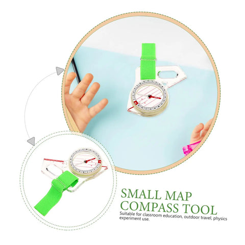 Thumb Type Directional Compass For Outdoor Navigation shown with a child's hand on light blue surface, green strap visible