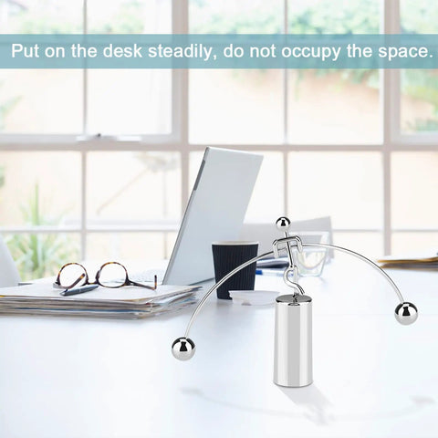 Newton's Cradle Desk Toy Dope Office Decor With Pendulum Motion on a modern office desk with a laptop and glasses
