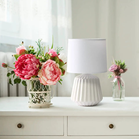 Petite Pleated Ceramic Table Lamp With Off White Fabric Shade 5 Ft Cord 40W Equivalent Type B Bulb Not Included Classic English Style Accent Light For Bedroom Or Living Room Cozy Glow beside flowers on white table