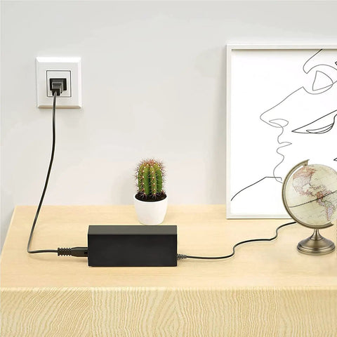 42V Fast Charger for Jetson Atlas Folding Fat Tire Electric Bike JATLASBLK on table with cactus and globe