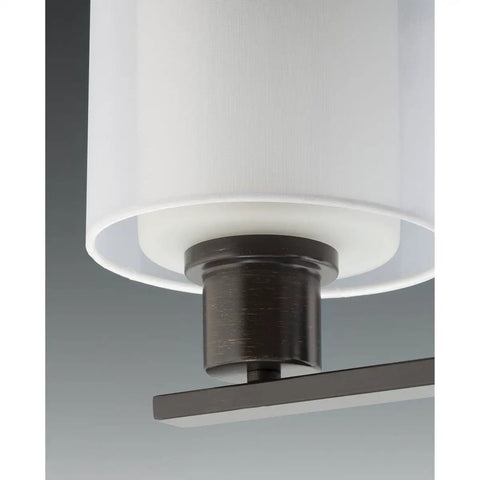 Close-up of four-light pendant in brushed nickel finish with white silk Mylar shade and inner glass globe, 20 inch modern design.