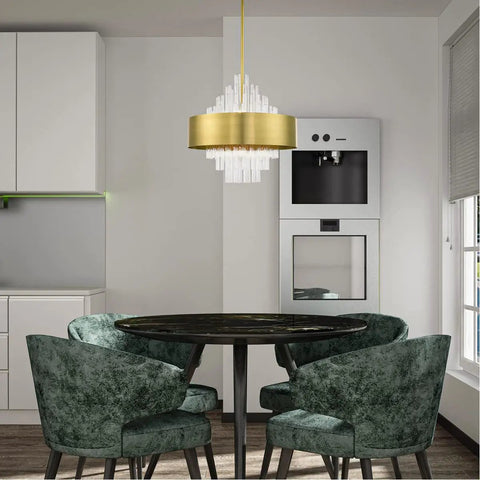 Absolute Flex Eight Light Natural Brass Pendant Chandelier With Sculpted Drum Shade And Dazzling Clear Crystal Rods For Upscale Living Areas That Turn Heads On A Dime above a round black dining table with green velvet chairs.