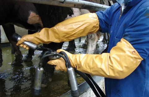 Person wearing Double Nitrile Coated Full Arm Chemical Resistant Safety Glove With Cotton Poly Liner, handling equipment.