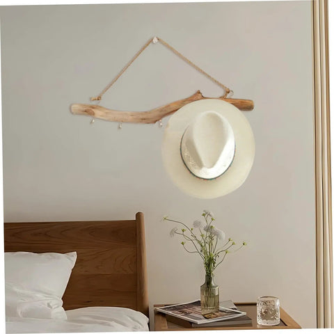 Badass 16 Inch Natural Wood Wall Hooks Featuring Five Curved Prongs For Hanging Heavy Jackets Tote Bags And Key Chains Inside Your Mudroom Or Entryway While Keeping Everything Slick And Organized, showcasing a hat on rustic driftwood.