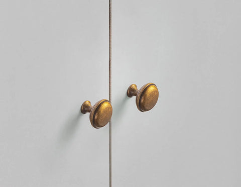 Antique Brass Cabinet Knobs 6 Pack Set, Zinc Alloy Drawer Pulls for Kitchen Cabinets mounted on white doors