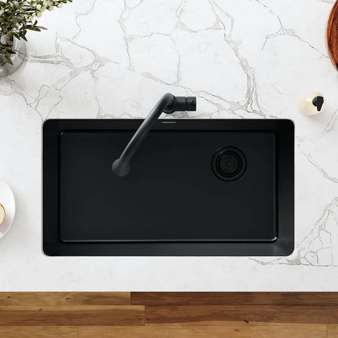 Top view of black sink with Polymer Drain Fitting With Removable Basket Strainer And Rubber Stopper in color-matched design.