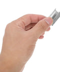 Close-up of hand holding Heavy-Duty Steel Strapping Clips With Iron Buckles 1Kg Pack For Packaging And Strap Fixing