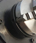 Close-up of 65mm chuck on Dead On Rotary Welding Positioner, showcasing precise gripping mechanism for tight fits.