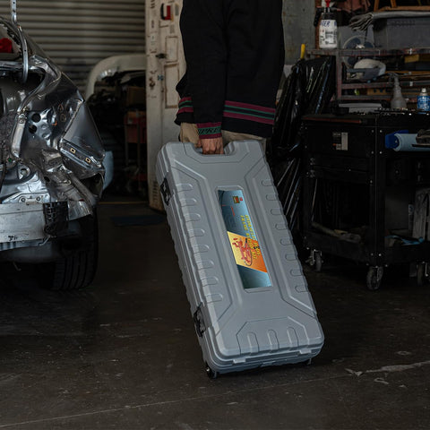10 Ton Hydraulic Porta Power Jack Ram Badass Auto Body Frame Repair Tool in sturdy gray carry case held by mechanic.
