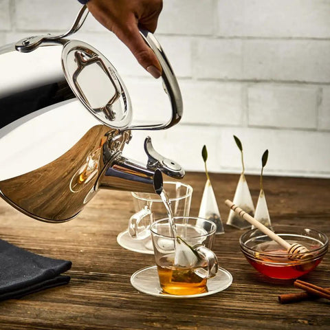 Pouring hot water from Specialty Stainless Steel Tea Kettle, 2 Quart, Induction Ready Pot with Visible Fill Line and Whistle into a cup