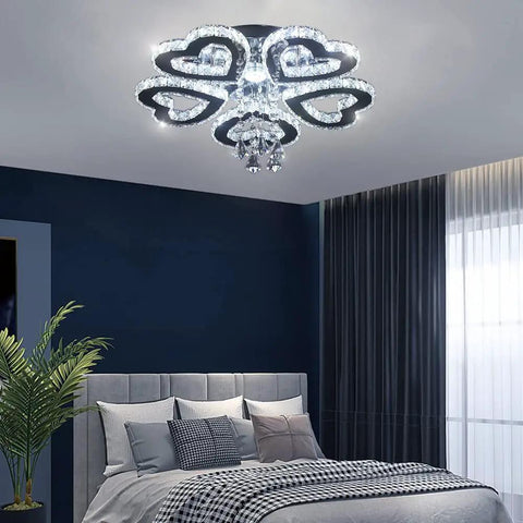 5 Heart Ring Crystal Chandelier LED Ceiling Light Fixture Stainless Steel Pendant Lighting in a bedroom setting