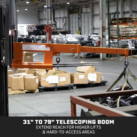Built Tough Fork Mounted Telescoping Jib Boom Crane With 5500 LB Lifting Power And Sweet 31 To 79 Inch Reach in warehouse setting.
