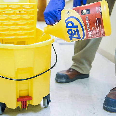 Top Shelf Heavy Duty Floor Cleaning Kit With Stripper Sealer Polish And Cleaner Four Gallon Set pouring floor stripper into yellow mop bucket.