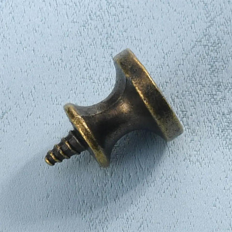 Slick 10 Piece Mini Drawer Knobs With Solid Antique Brass Finish And Hella Durable Rustproof Metal Hardware For Sweet Cabinet Makeovers Including No Sweat Self Tapping Screws For Quick DIY Swaps close-up of a mini drawer knob with screw.