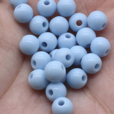 Top Shelf Black Round Spacer Beads 14mm Bulk 500G Pack Smooth Polished Finish Perfect For DIY Jewelry Making in hand.