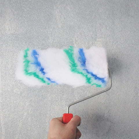 Person using Premium Mini Paint Roller Covers 24 Pack Polyester Sleeves For Wall Painting with colorful paint on wall.