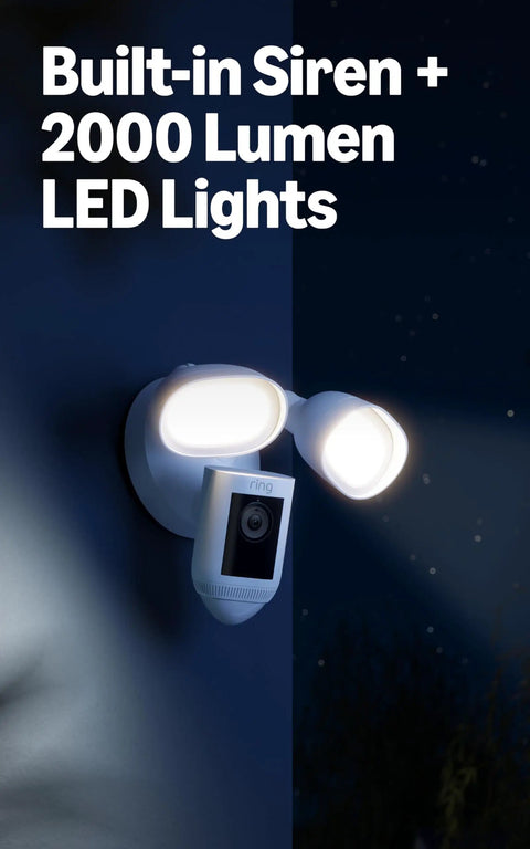 Floodlight Pro Security Camera With Retinal 2K Video Color Night Vision Two Way Talk And Audio 3D Motion Detection Built In 110 dB Siren Perfect For Home Or Biz Outdoor Security mounted on wall with LED lights glowing.