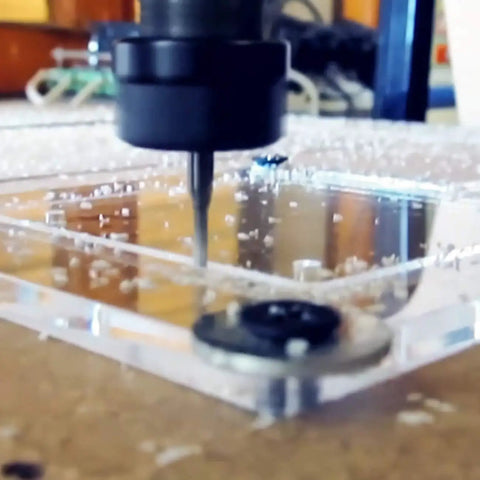 CNC machine using Two Flute Upcut Carbide End Mill Set With One Eighth Inch Shank Flat Nose for precise cutting and engraving.