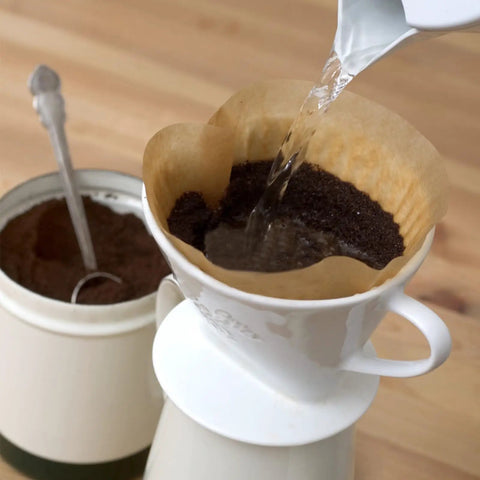 Pouring water over grounds in 200 Count Unbleached Cone Coffee Filters for Drip and Pour Over brewing, fits 2-6 cup makers